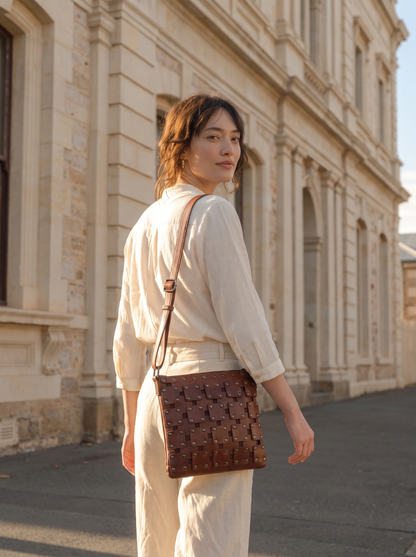 Gawler Sling crossbody bag worn over the shoulder, shown from behind beside a stone building facade